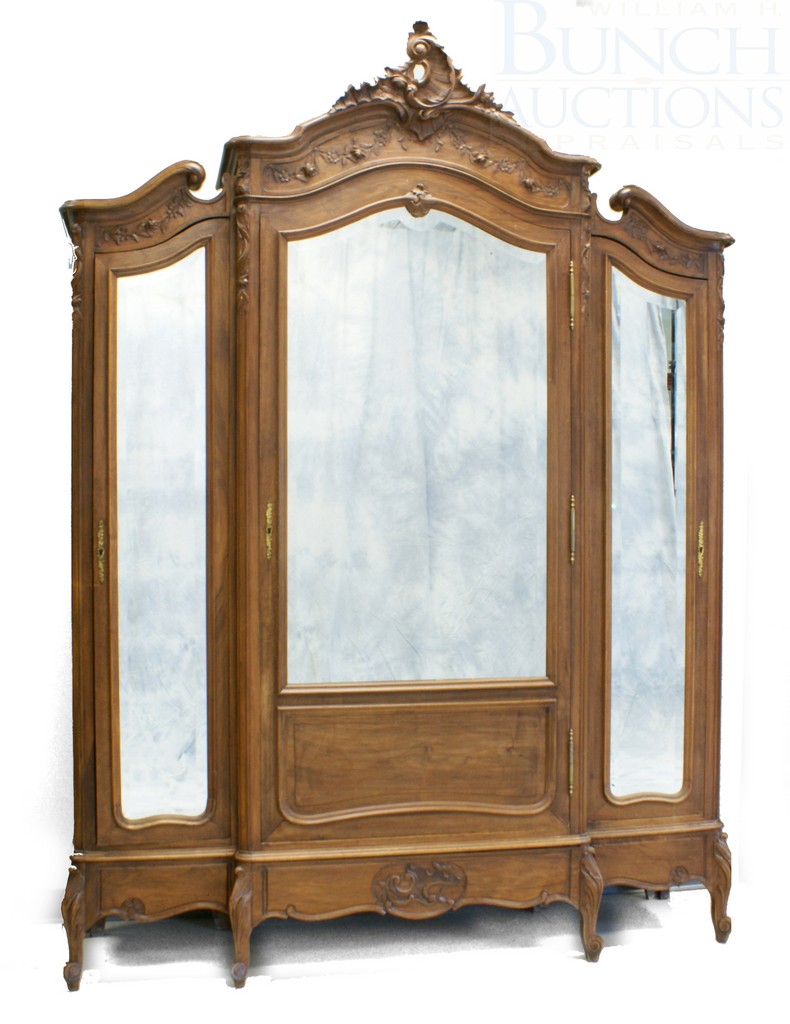 Appraisal: Section Carved Walnut French Armoire with beveled mirrored doors center