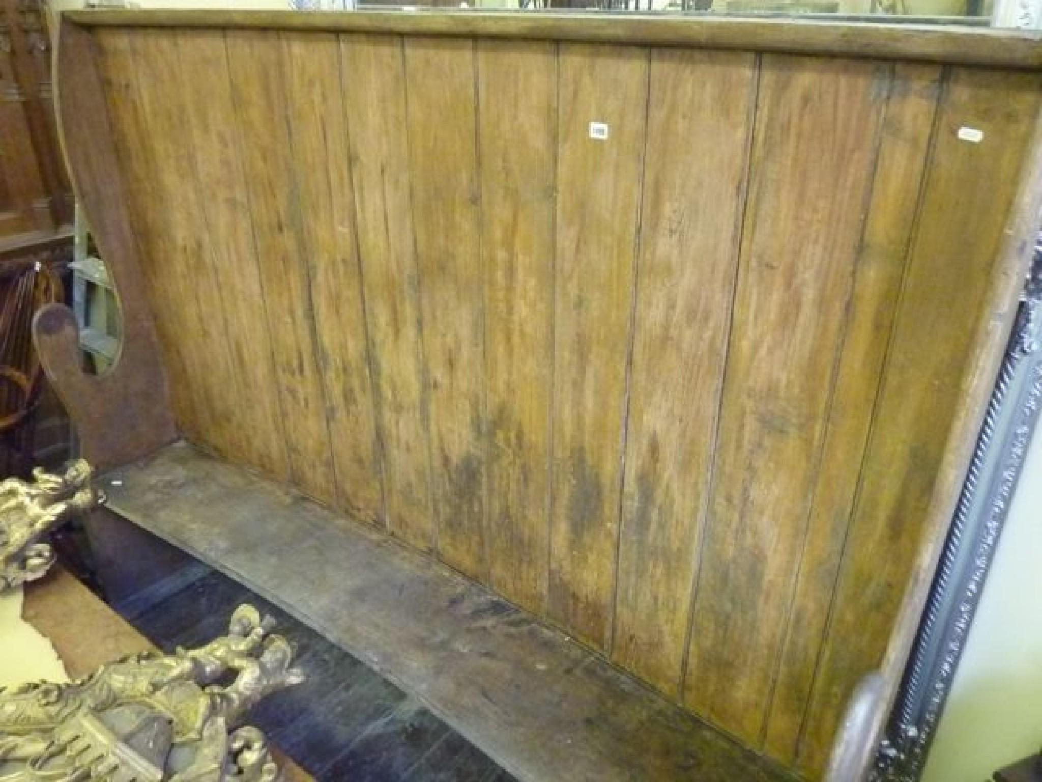 Appraisal: A th century stained pine settle with boarded back flanked