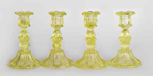 Appraisal: Four sandwich vaseline glass candlesticks ca h