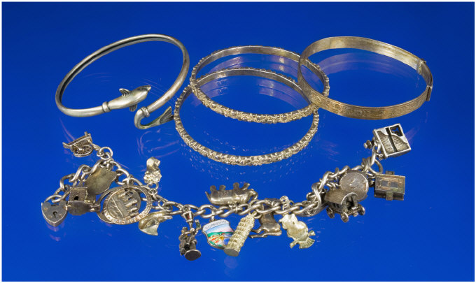 Appraisal: Small Collection Of Jewellery Comprising Silver Bangles And A Charm