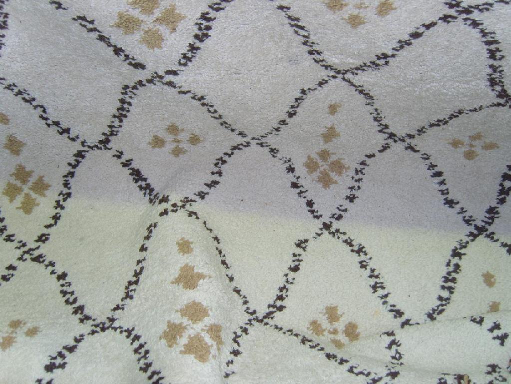 Appraisal: A cream ground wool rug with lattice decoration in light