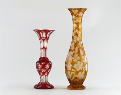 Appraisal: A ruby-flashed glass vase with a long flared and faceted