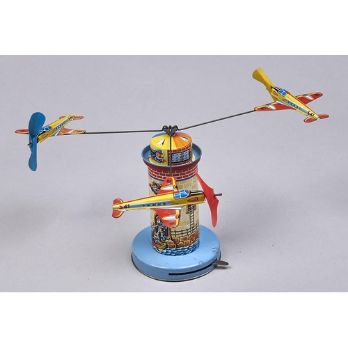 Appraisal: A lithographed tinplate and plastic clockwork spinning aircraft lighthouse toy