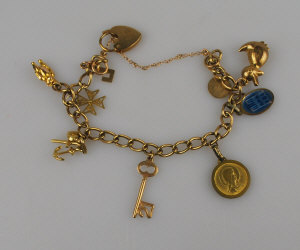 Appraisal: ct yellow gold curb bracelet having various charms attached mostly