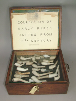 Appraisal: A collection of antique clay pipe bowls in a mahogany