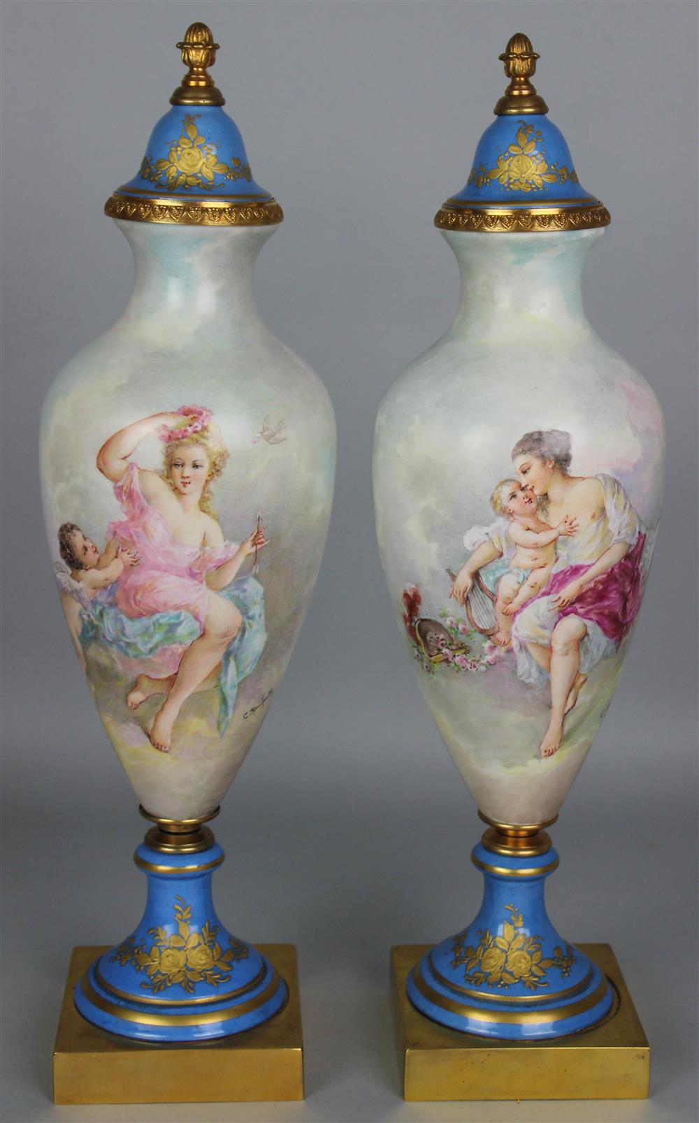 Appraisal: PAIR OF SEVRES STYLE PORCELAIN PAINTED COVERED URNS late th