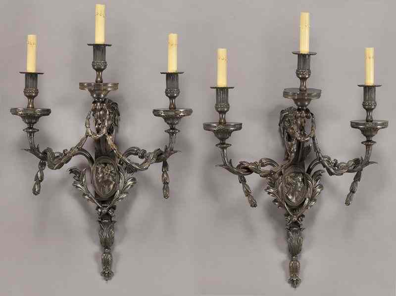 Appraisal: Pr French bronze three-light sconces centered bymale and female portraits