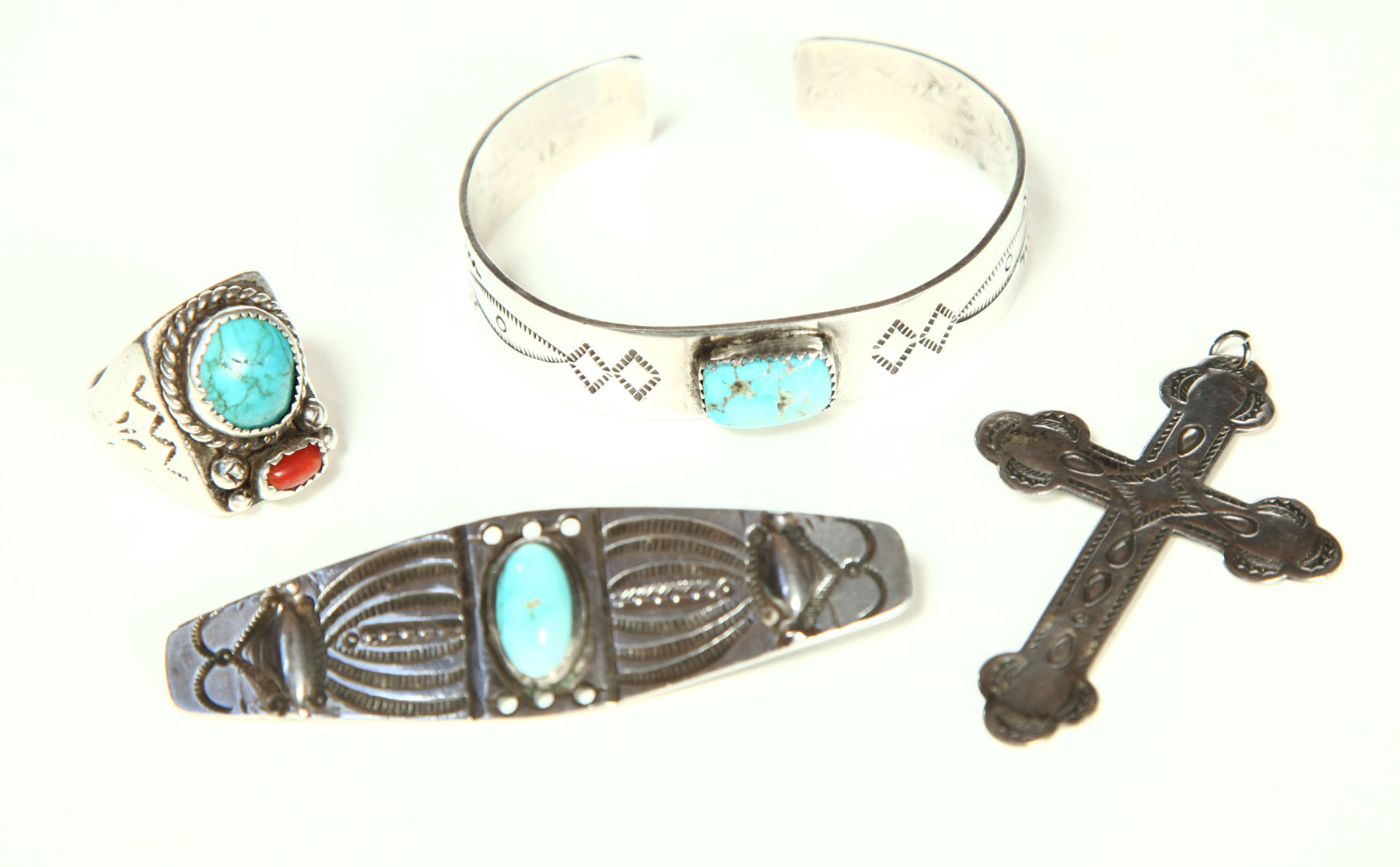 Appraisal: FOUR PIECES OF NAVAJO JEWELRY Twentieth century Silver Tooled vintage