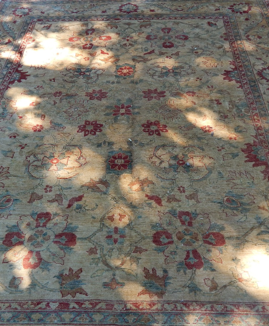 Appraisal: An Oriental style rug on beige ground cm x cm