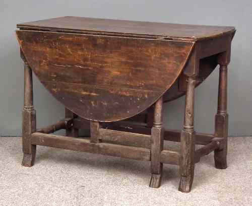 Appraisal: An early th Century oak oval gateleg table on plain