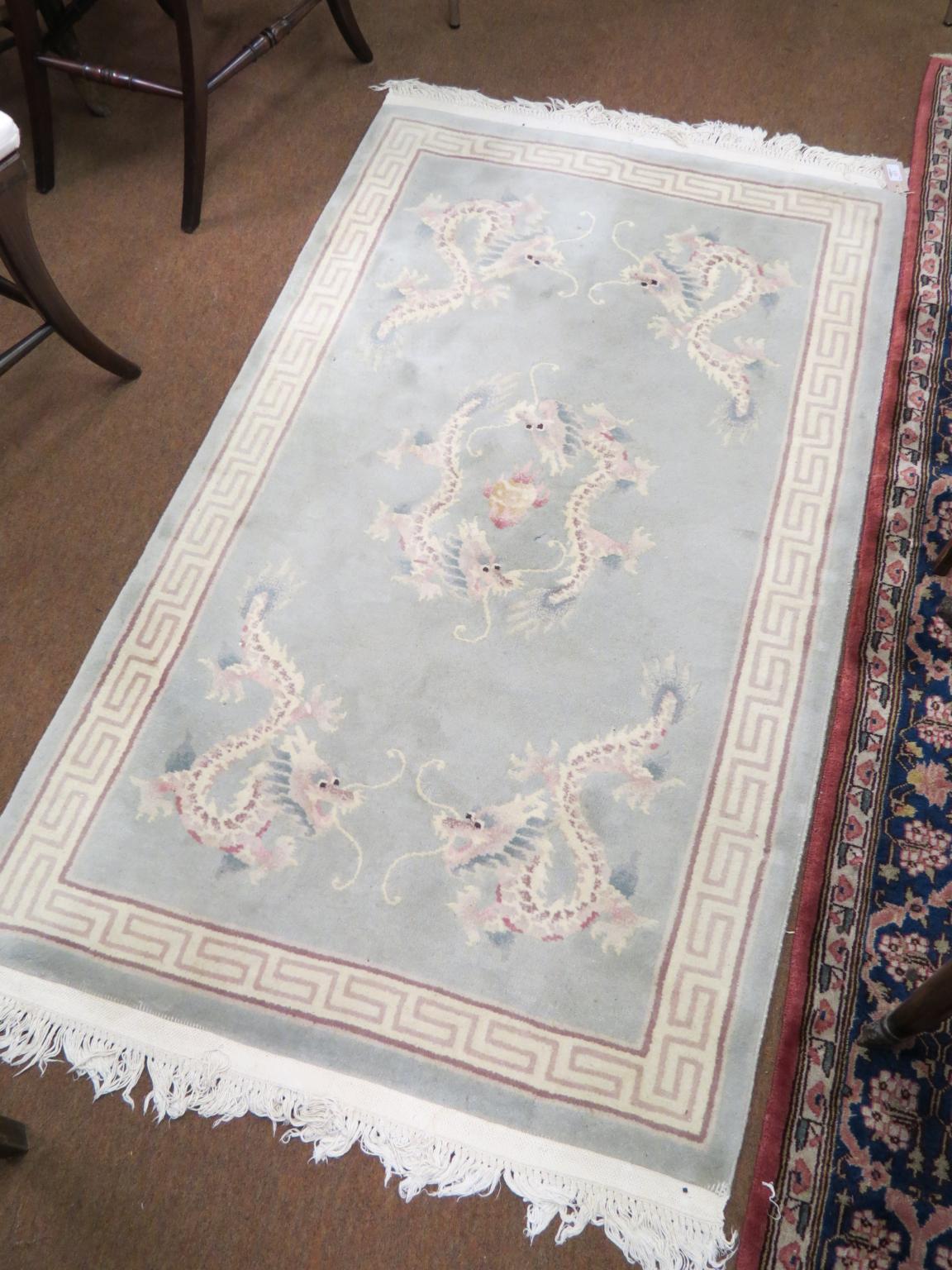 Appraisal: A Chinese wool rug dragon design against a celadon field