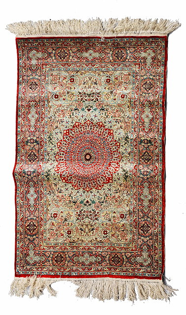 Appraisal: A TURKISH HEREKE SILK MAT with a central red ground