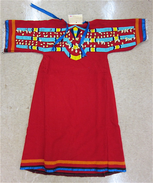 Appraisal: NATIVE AMERICAN RED WOOL DRESS with cowry shell and glass