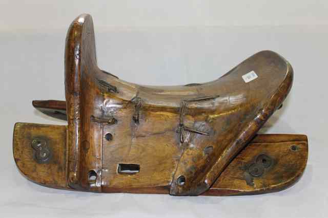 Appraisal: A CHINESE WOODEN SADDLE with iron mounts