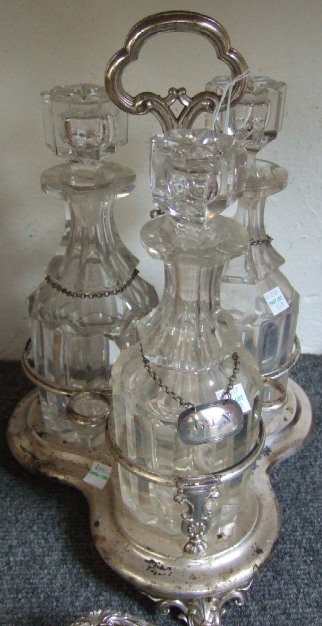 Appraisal: A plated triple section decanter stand fitted with three faceted