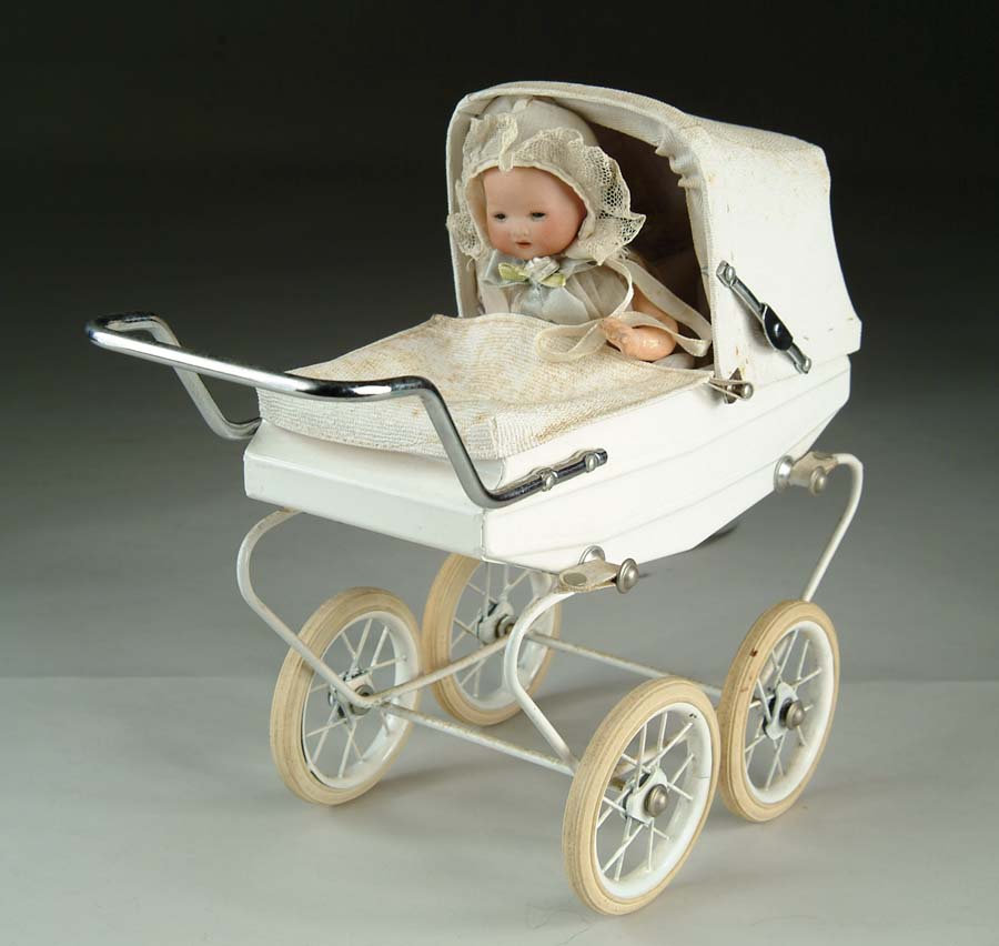 Appraisal: CARRIAGE WITH AM CHARACTER BABY DOLL RIDING INSIDE German bisque