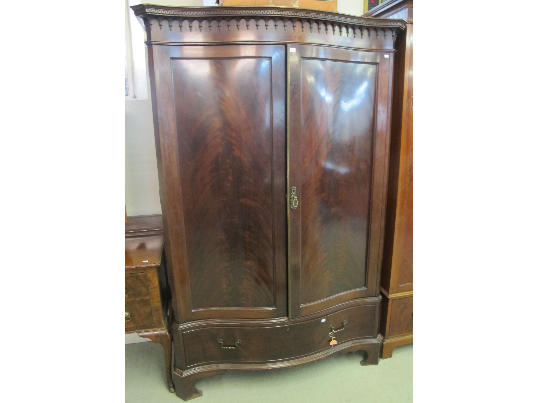 Appraisal: A mahogany serpentine front two door wardrobe