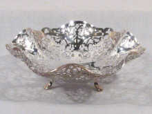 Appraisal: A pierced silver sweet dish on three feet hallmarked Sheffield