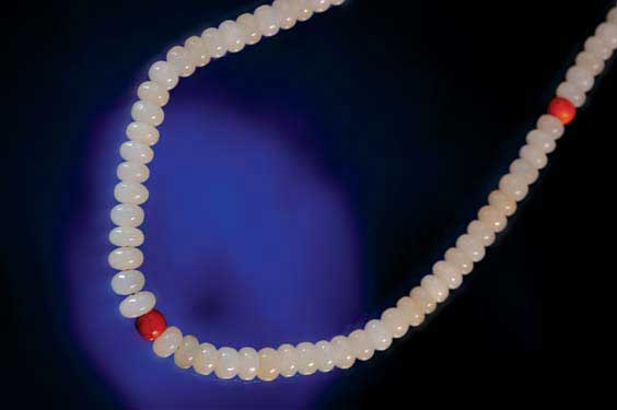 Appraisal: JADE AND CORAL BUDDHIST BEADS Buddhist strand of Chinese white