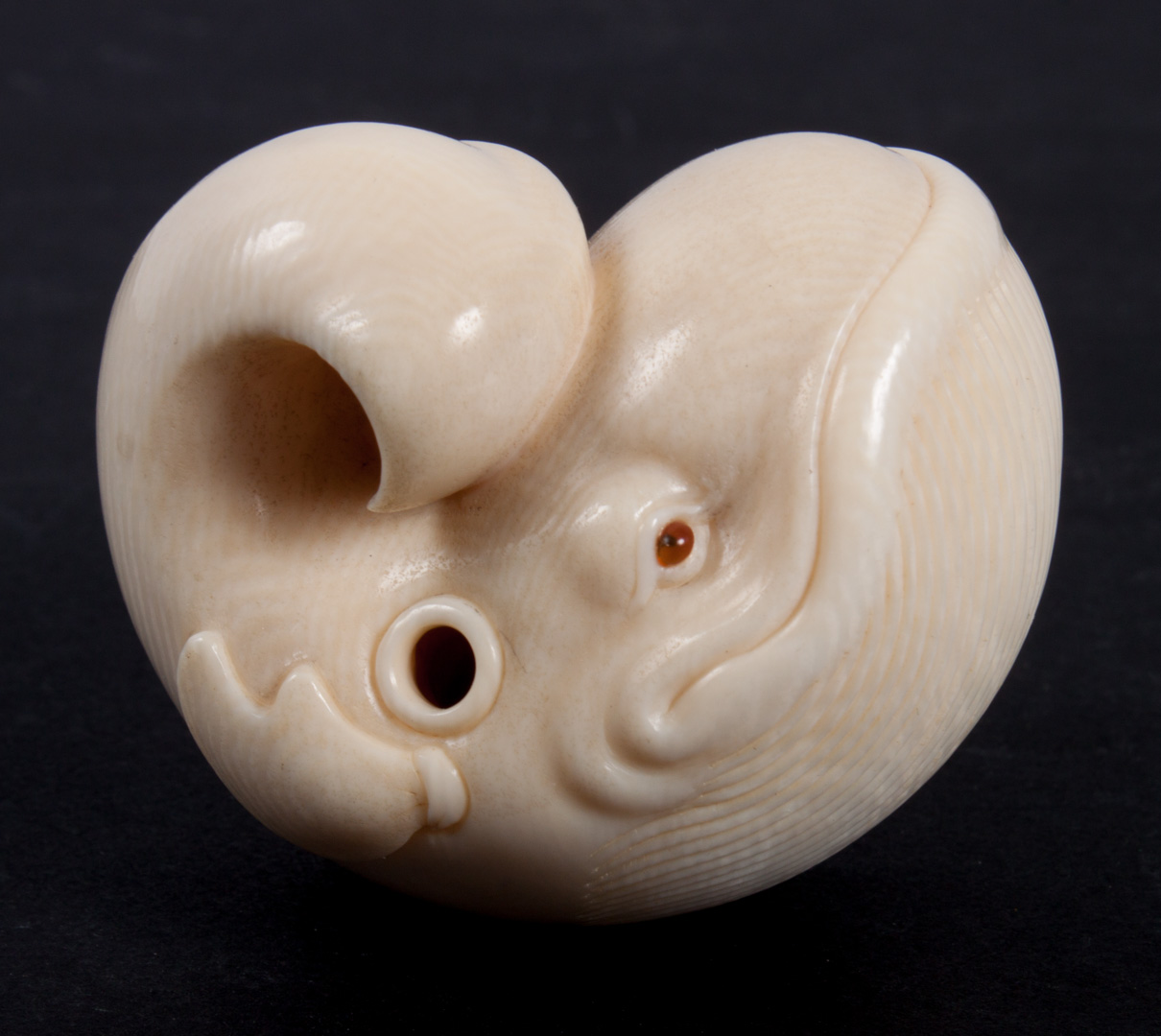 Appraisal: Japanese carved ivory whale netsuke with etched signature in L