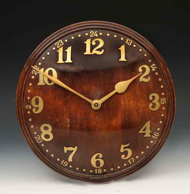 Appraisal: A Zenith oak hour wall clock the circular dial with