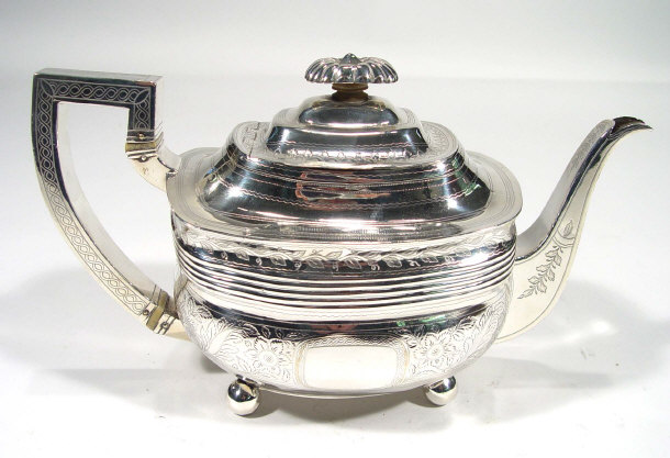 Appraisal: Georgian silver teapot with floral chased decoration and ivory bands