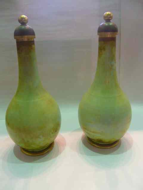 Appraisal: A PAIR OF GREEN SPECKLE PORCELAIN BOTTLE VASES and covers