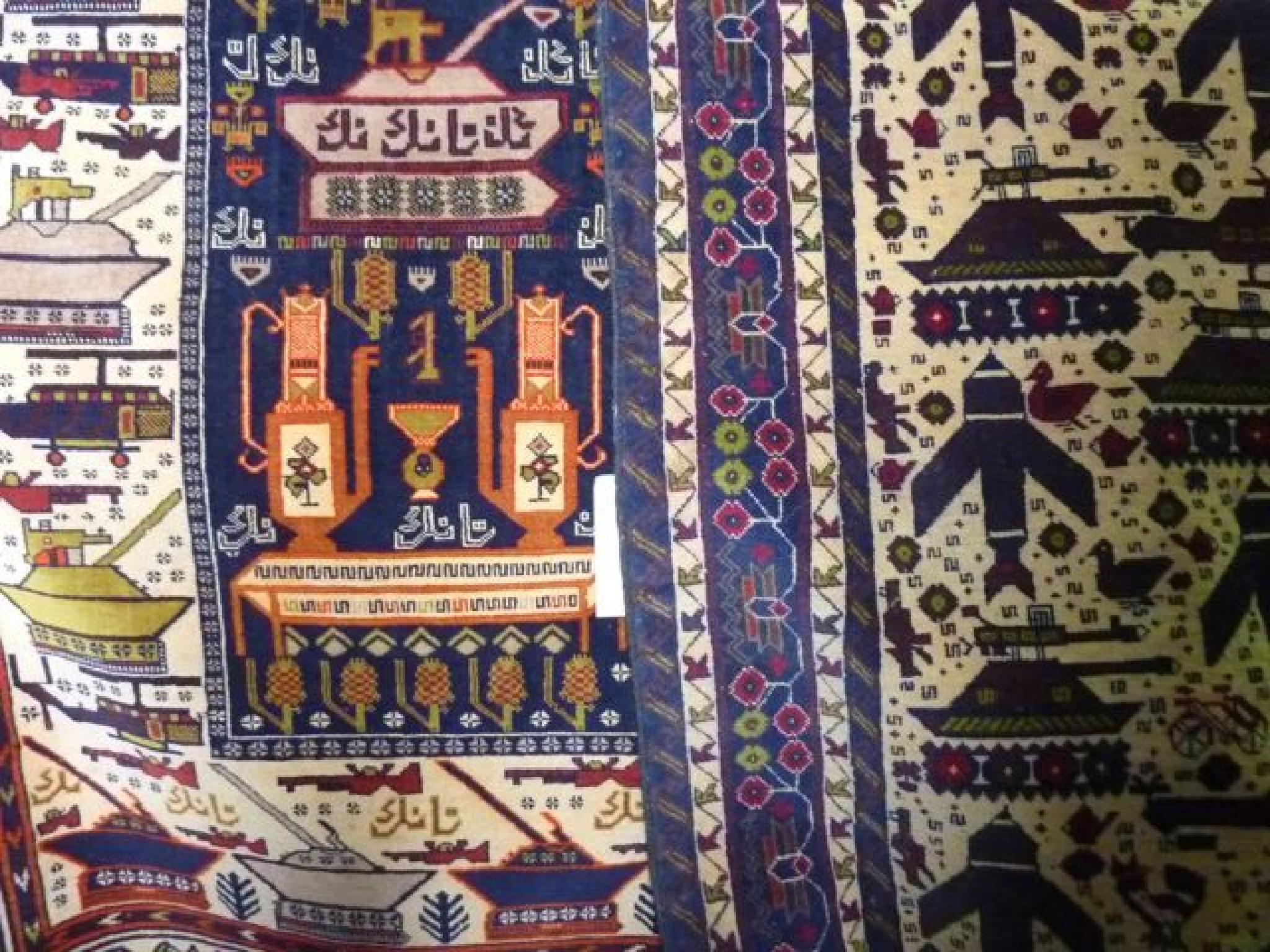 Appraisal: Two contemporary Persian rugs each showing weapons of war including