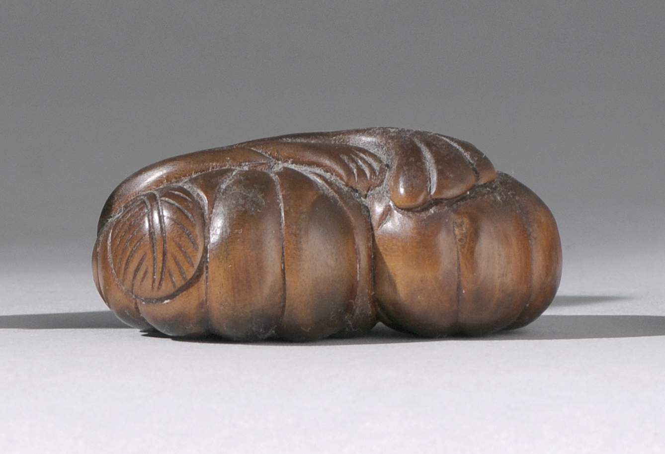 Appraisal: CARVED WOOD NETSUKE Meiji PeriodBy Ishiyama depicting two pumpkins on