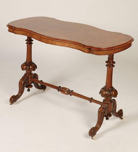 Appraisal: A VICTORIAN WALNUT CENTRE TABLE with a shaped top with