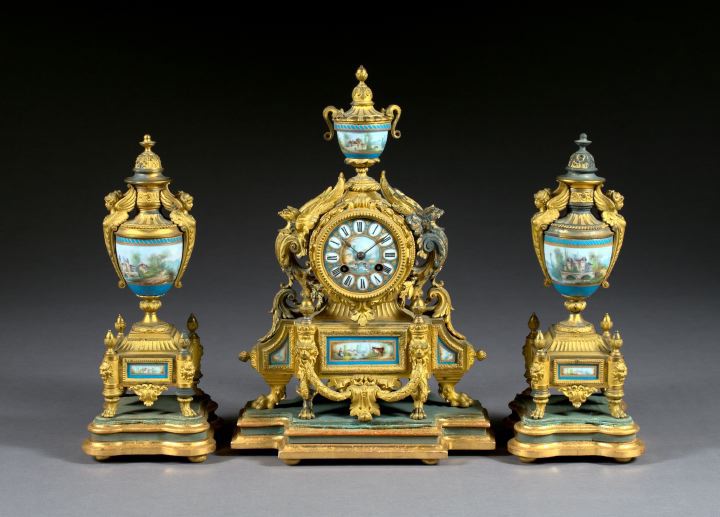 Appraisal: Three-Piece French Porcelain-Mounted Gilt Spelter and Carved Giltwood Mantel Garniture