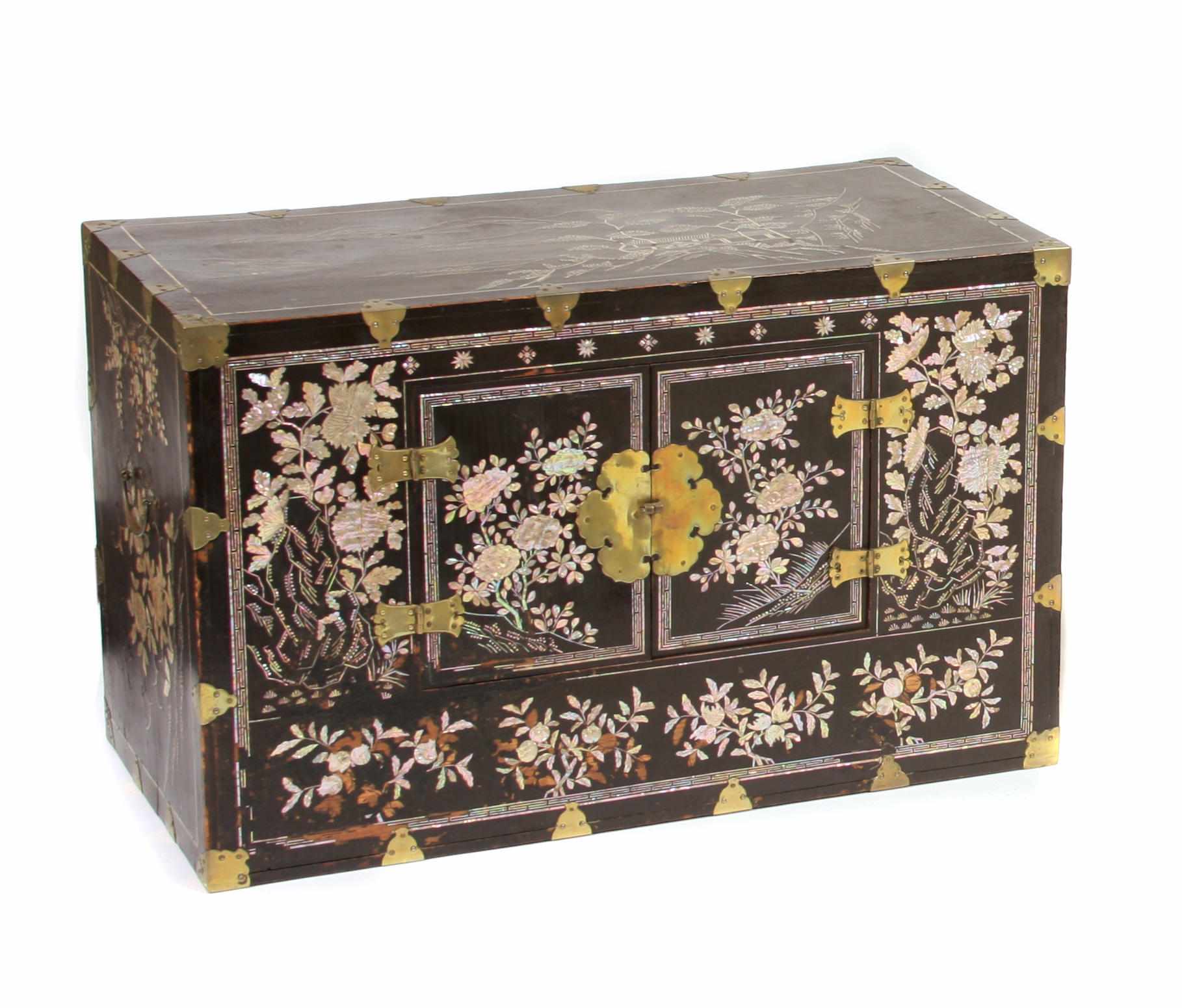 Appraisal: An Asian lacquered wood chest with ivory and hardstone inlay