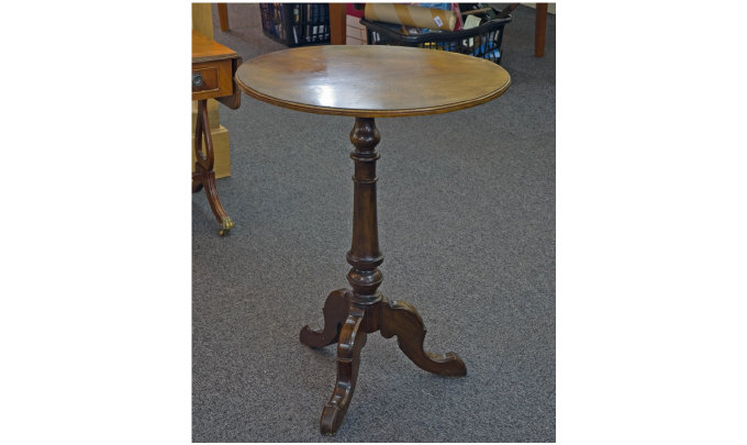 Appraisal: A Mahogany Tripod Table On carved and turned column Supported