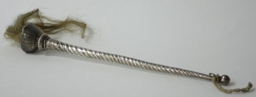 Appraisal: An Eastern white metal fly whisk handle with tapering twisted