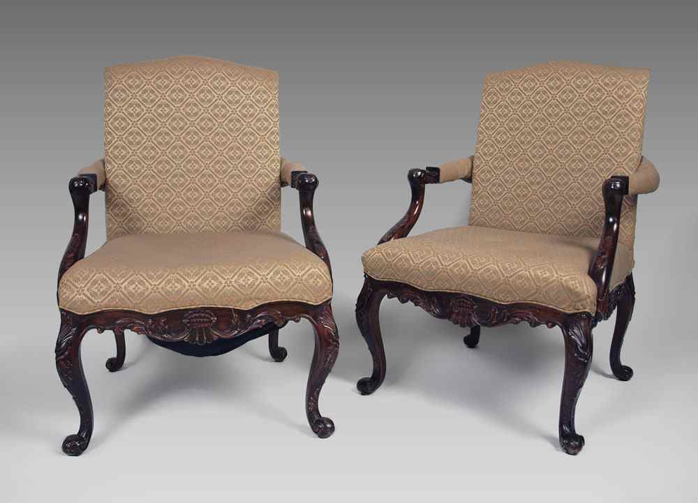 Appraisal: PAIR CARVED MAHOGANY OPEN ARM CHAIRS Finely carved skirt and