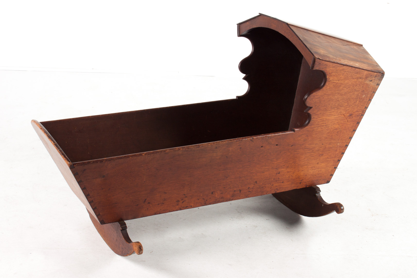 Appraisal: American vernacular walnut rocking cradle late th century paneled hood