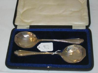 Appraisal: A PAIR OF FRUIT SERVING SPOONS the reeded haft with