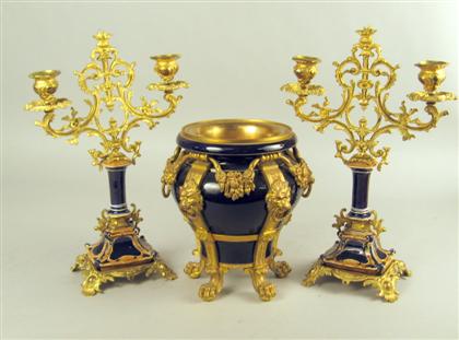 Appraisal: Continental gilt metal porcelain three-piece garniture Comprising a blue glazed