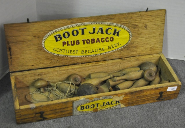 Appraisal: Boot Jack Plug Tobacco BoxWith a child's tin pin toy