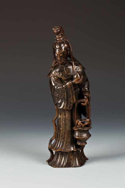 Appraisal: A CHINESE SOAPSTONE FIGURE of Guan Yin standing wearing flowing