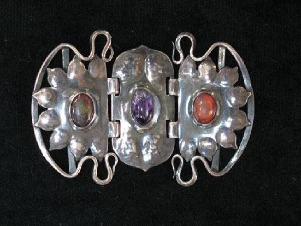 Appraisal: A SILVER BUCKLE stylised as two sun-bursts and set with