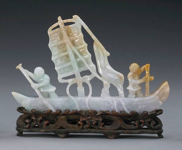 Appraisal: A mottled jadeite model of a sailing vessel The narrow