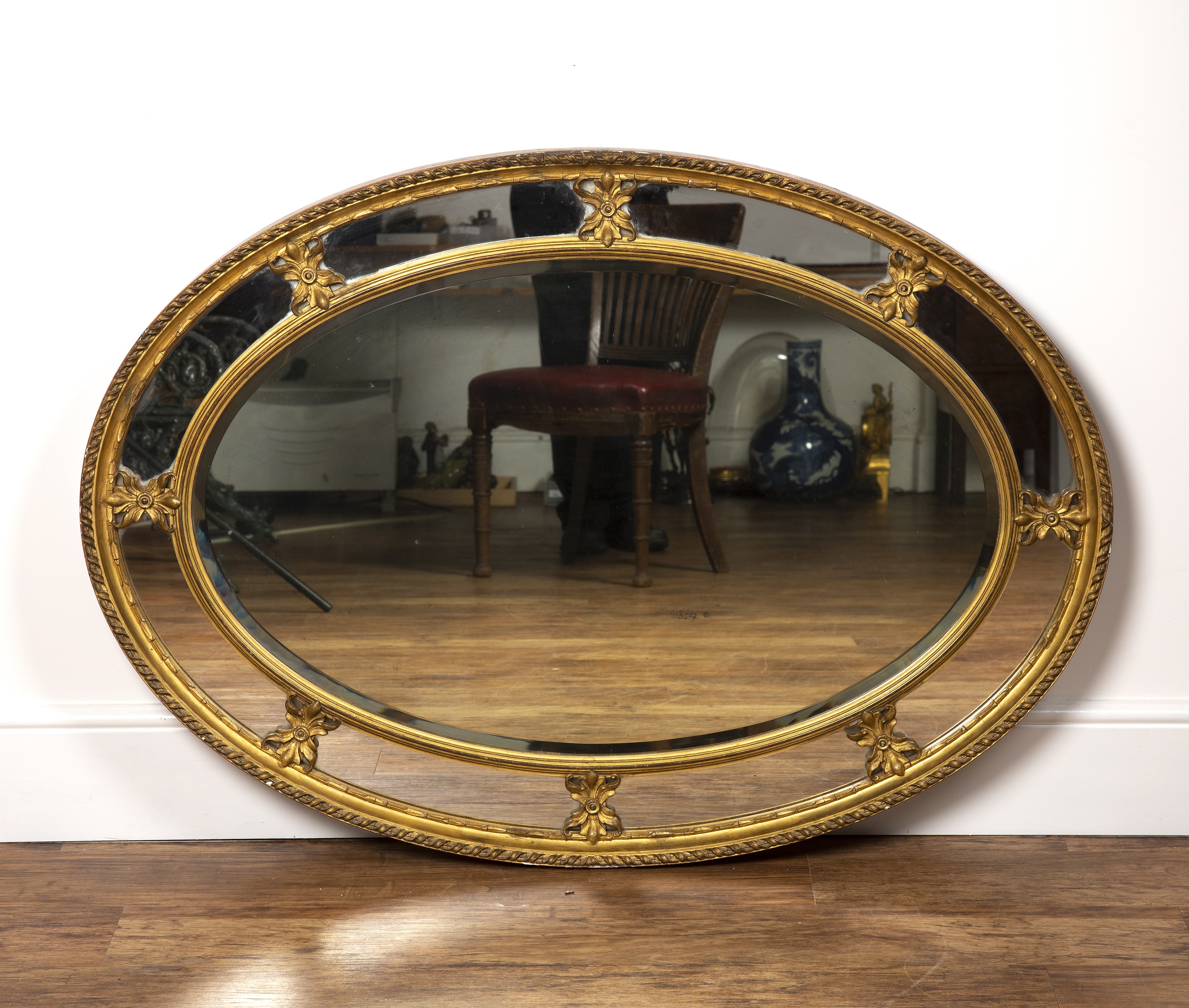 Appraisal: Oval gilt plaster wall mirror th Century with ribbon border