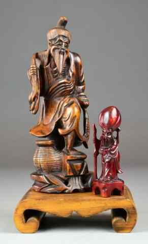 Appraisal: Chinese Carved Wood Figures and StandTwo wooden Chinese carved figures