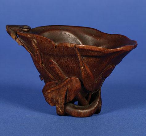 Appraisal: A CHINESE RHINOCEROS HORN LIBATION CUP of foliate form supported