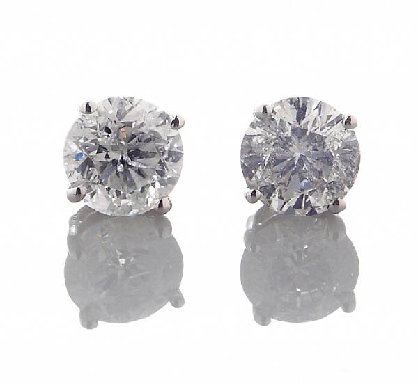 Appraisal: A pair of diamond solitaire earrings estimated total diamond weight