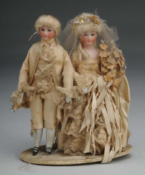 Appraisal: Pair of Simon Halbig Costume Dolls Description Germany Ca Bisque