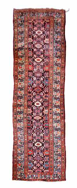 Appraisal: A KURDISH LONG RUNNER decorated with central foliate motif within