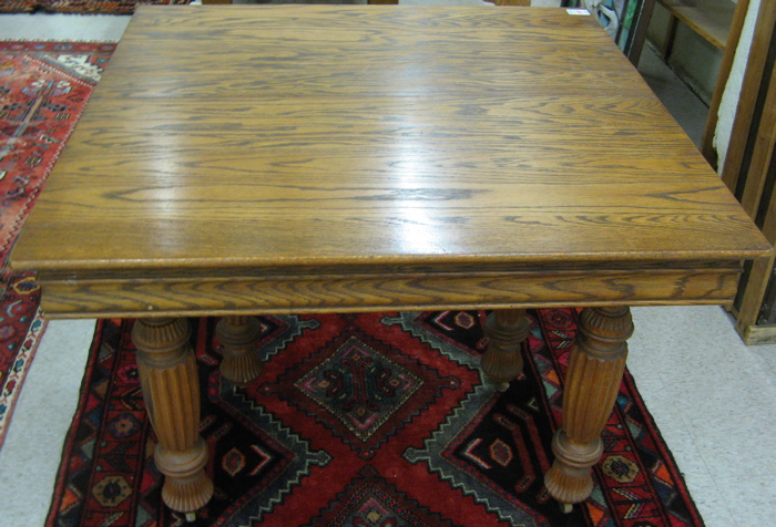 Appraisal: A SQUARE OAK DINING TABLE WITH EIGHT LEAVES American c