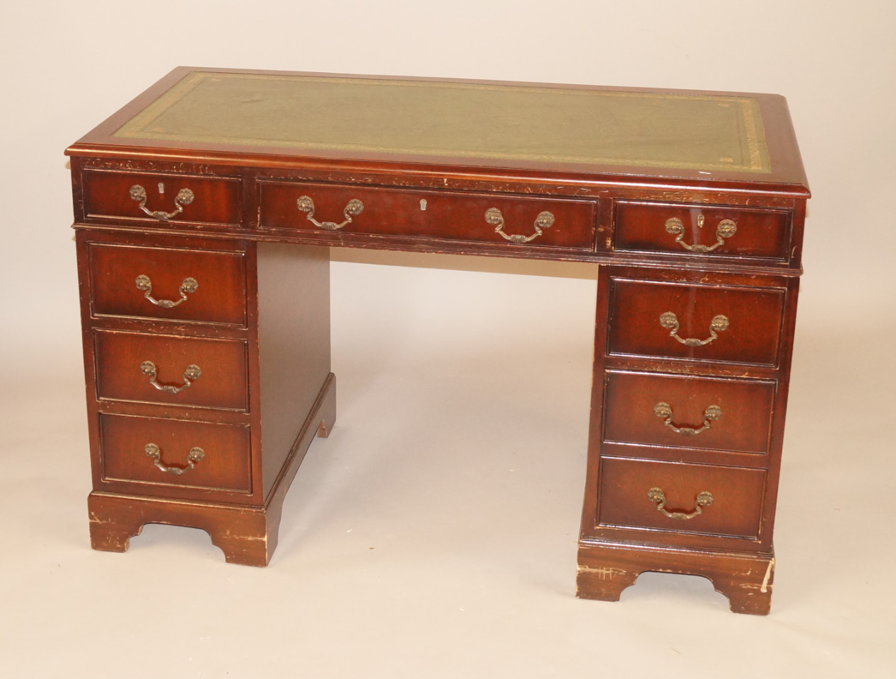 Appraisal: A reproduction mahogany pedestal desk the rectangular top with a